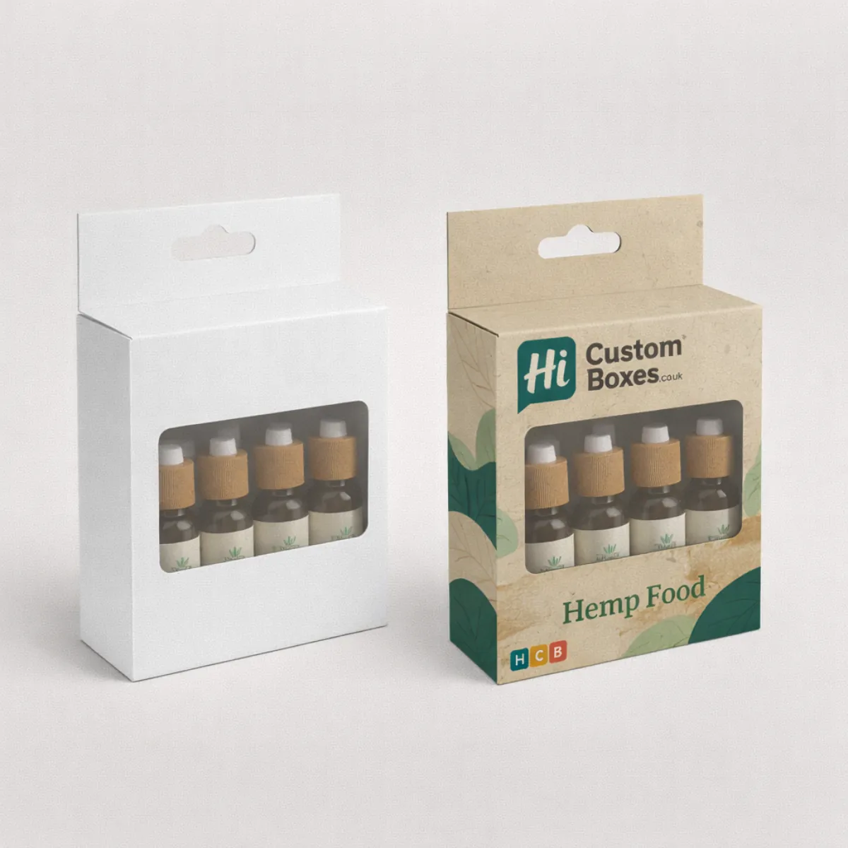Cardboard hanging boxes with windows displaying small oil bottles- showing a white and a custom-printed option- class=